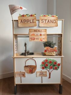 an apple stand with wooden signs on it