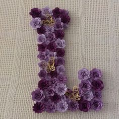 the letter j is made up of purple flowers