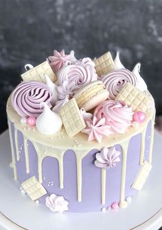 a purple and white cake with icing on top