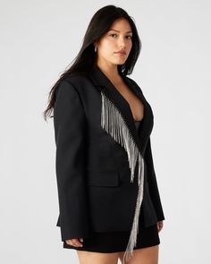 The NELLIE blazer is a stunning, single-breasted blazer that features rhinestone fringe detailing and functional flap pockets. Designed with a back vent and faux chest welt pockets, this blazer offers a touch of glamour and sophistication to any outfit. Perfect for work or special occasions. Rhinestone fringe blazer Single-breasted Two functional front pockets Length: 28.5" 97% polyester 3% elastane Hand wash Amelia is 5ft 10.5in and is wearing a size small Vanessa is 5ft 8in and is wearing a si Glamorous Notch Lapel Blazer For Fall, Glamorous Notch Lapel Blazer For Workwear, Glamorous Notch Lapel Outerwear For Night Out, Chic Embellished Office Blazer, Chic Notch Lapel Embellished Blazer, Glamorous Tailored Outerwear With Notch Lapel, Chic Embellished Blazer With Notch Lapel, Glamorous Tailored Blazer For Workwear, Glamorous Tailored Blazer For Fall