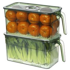 two clear containers filled with oranges and celery on top of each other