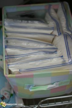 a shopping cart filled with lots of plastic bags next to a pile of paper towels