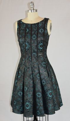 This is a fun, beautiful dancing party dress. The maker is Ivy and Blue, and was made in China. It is a size 2. The fabric is unknown but is soft with turquoise and copper brown metallic threads. The dress is lined, and the skirt has hidden seam pockets! The beaded scarf is included but was not original to the dress. Elegant Turquoise Festive Dress, Elegant Turquoise Dress For Festive Occasions, Green Brocade Party Dresses, Fitted Turquoise Dress For Festive Occasions, Festive Turquoise Dress For Party, Festive Turquoise Party Dress, Dancing Party, Beaded Scarf, Sugar Land