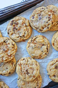 chocolate chip cookies sitting on top of parchment paper