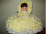 a doll is dressed in a yellow dress