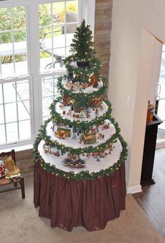 a christmas tree that is in the middle of a room