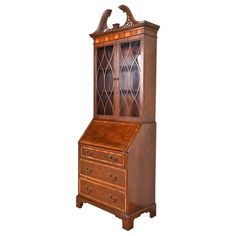 an antique wooden bureau with glass doors and drawers