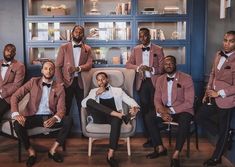 a group of men in tuxedos posing for a photo