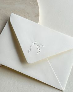 two white envelopes sitting next to each other