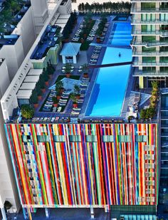 an aerial view of the pool and surrounding buildings with colorful lines painted on the side