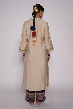 Ivory chanderi kurta with zardozi embroidered yoke. Comes with chanderi purple pant with embroidered hem and purple organza dupatta.
Component: 3
Pattern: Embroidered
Type Of Work: Zardozi Floral Motifs
Neckline: V-Neck
Sleeve Type: Three Quarter
Fabric: Kurta and Pant: Chanderi, Dupatta: Organza
Color: Ivory
Other Details: 
Lined kurta
Embroidered pant hem
Sequin and gota floral pattern on dupatta
Embroidered dupatta hem with fringed lace
Occasion: Puja - Aza Fashions Off White Bohemian Traditional Wear For Festive Occasions, Festive Bohemian Cream Traditional Wear, Traditional Beige Dupatta With Dabka Embroidery, Traditional Beige Dupatta With Dabka, Cream Bohemian Traditional Wear For Festive Occasions, Bohemian Beige Traditional Wear For Festive Occasions, Beige Bohemian Traditional Wear For Festive Occasions, Unstitched Cream Kurta With Gota Work, Bohemian Raw Silk Kurta With Chikankari Embroidery