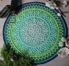 a green and white round rug sitting on top of a table