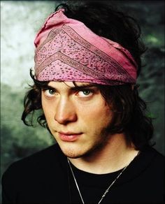 a man with a pink bandana on his head