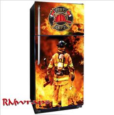 a fireman standing in front of a refrigerator that has flames on it and the door is open