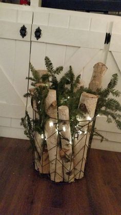 a basket filled with wrapped presents sitting on top of a wooden floor next to a white door