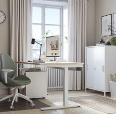 an office with a desk and chair in front of a window that has curtains on the windowsill