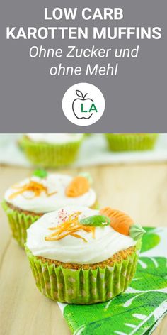 two cupcakes with white frosting and carrots on them are sitting on a green napkin