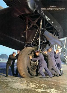 men working on an airplane in front of it