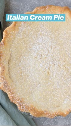 an uncooked pie with powdered sugar on top and napkins next to it