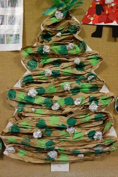 a christmas tree made out of brown paper with green and silver decorations on it's branches