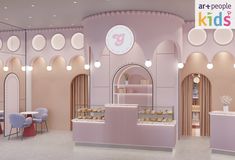 the interior of a children's store with pink walls and arches, round windows, and circular lights