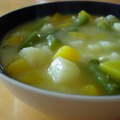 a white bowl filled with soup on top of a table