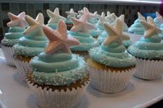 cupcakes with blue frosting and starfish decorations