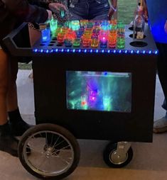 people standing around a table with drinks on it