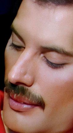 a close up of a person with a moustache on his face and nose