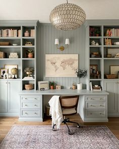 a home office with built - in bookcases, desk and rug on the floor