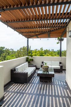 an outdoor living area with couches and tables