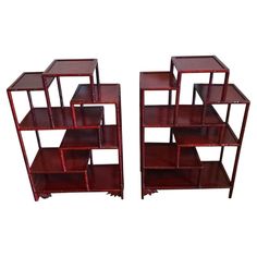 a set of three red shelves sitting next to each other on top of a white background