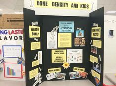 a bulletin board with pictures and information about bones, density and kids on it in a classroom setting