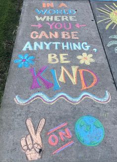 the sidewalk has chalk writing on it that says, i am world where you can be anything