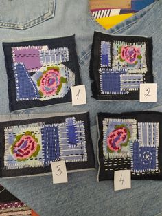 four pieces of fabric with flowers and numbers on them are displayed in the back pocket of a pair of jeans