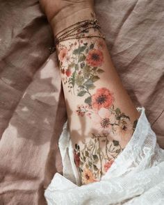 a woman's arm with flowers on it