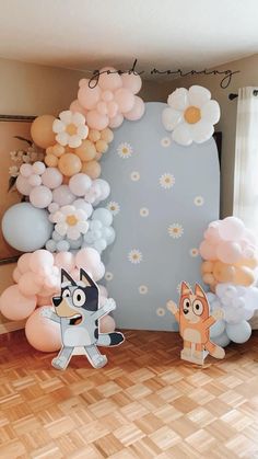 a room with balloons, flowers and animals on the floor in front of a wall