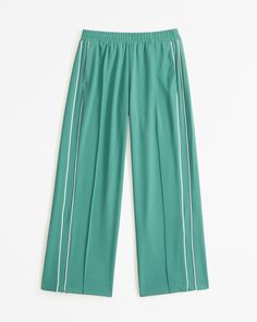 Mid rise, wide leg pants in a drapey rayon fabric, featuring a pull-on style elasticated waistband and functional pockets. Trendy Green Wide Leg Pants With Side Pockets, Trendy Green Relaxed Fit Wide Leg Pants, Trendy Green Wide Leg Pants With Relaxed Fit, Green Sweatpants With Elastic Waistband For Spring, Green Elastic Waistband Sweatpants For Spring, Green Ankle-length Sweatpants With Elastic Waistband, Green Wide Leg Pants With Side Pockets, Spring Pants With Elastic Side Panels And Relaxed Fit, Summer Relaxed Fit Pants With Elastic Side Panels