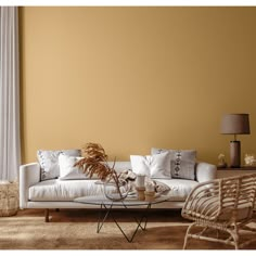 a living room filled with furniture next to a tall white window covered in drapes