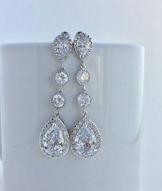 I've created these gorgeous!! luxury long clear cubic zirconia bridal tear drop earrings in rhodium plated brass setting. Earrings feature a large teardrop with pear cut clear cubic zirconia center surrounded by tiny round zirconia crystals. Teardrop dangles from a bright cubic zirconia ear stud and two round cubic zirconia connectors. Total length of the earrings is 6 cms. For matching necklace click: https://www.etsy.com/listing/255284201/long-clear-cubic-zirconia-bridal?ref=shop_home_active_1 Wedding Teardrop Earrings In Diamond White Cubic Zirconia, Sparkling Cubic Zirconia Teardrop Earrings For Wedding, Long Drop Silver Crystal Earrings For Weddings, Diamond Teardrop Dangle Earrings For Wedding, Diamond Dangle Teardrop Earrings For Wedding, Pear-shaped Cubic Zirconia Chandelier Earrings For Wedding, Silver Teardrop Pendant Bridal Earrings For Wedding, Silver Teardrop Pendant Bridal Earrings, Wedding Long Drop Chandelier Earrings With Sparkling Stones