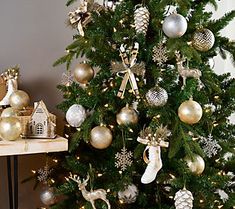 a decorated christmas tree with gold and silver ornaments