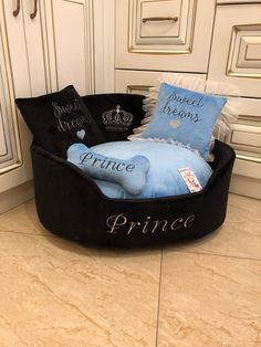 a black and blue bed with princess pillows on it