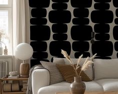 a living room with black and white wallpaper