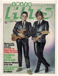 two men in black leathers are playing guitars on the cover of smash hits magazine