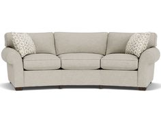 a beige couch with two pillows on it