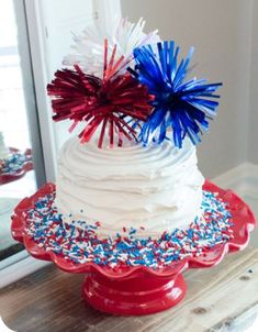 a white cake with red, white and blue sprinkles on the top