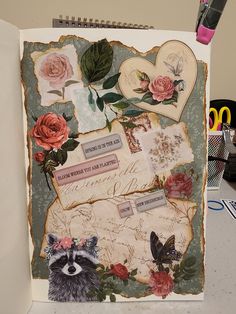 an altered photograph with flowers, hearts and other things in it on a table next to some pens