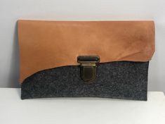 Minimalist clutch made of 100% wool felt. It has a flap made of brown leather. It is closed with a buckle. It is unlined with no other inside pocket.  Single piece  25cm x 15cm Design & Made in Germany Felt Clutch, Minimalist Clutch, Minimalist Purse, Concrete Jewelry, Grey Bag, Unique Purses, Felt Bag, Chain Choker Necklace, Wood Jewellery