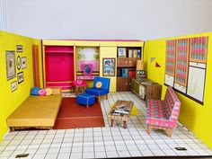 a doll house with furniture and pictures on the walls