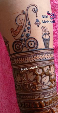 a woman's leg with hendi tattoos on it